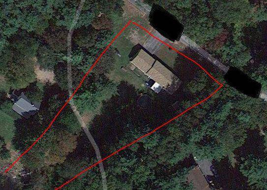 Aerial view of the private residence property with identifying information obscured