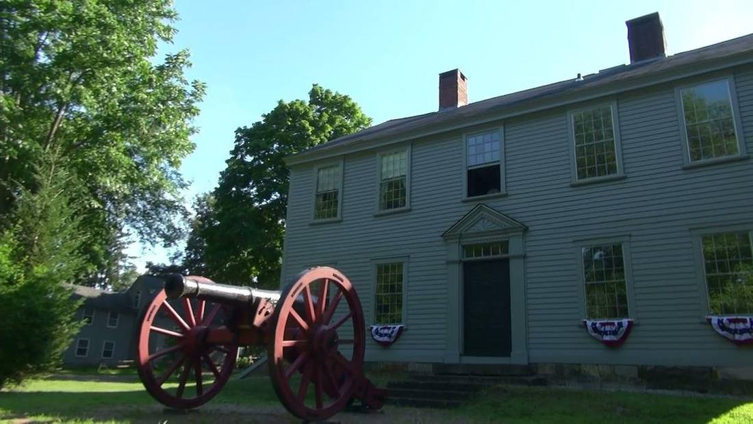 Nathanael Greene Homestead with a historic cannon in the foreground